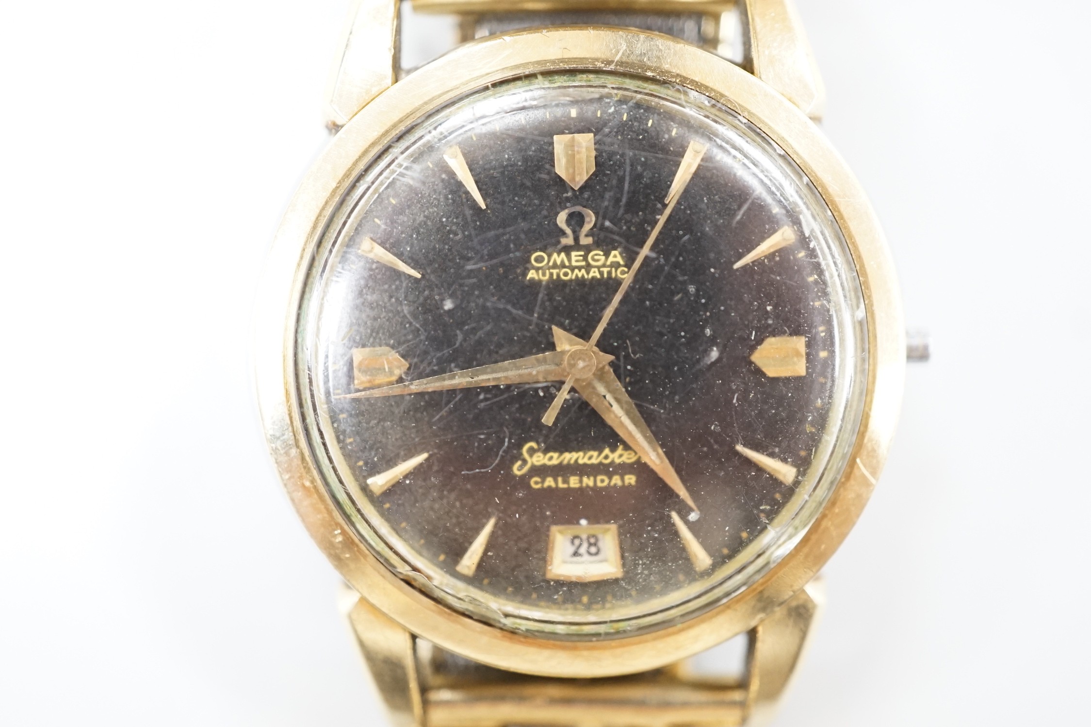 A gentleman's steel and gold plated Omega Seamaster Calendar automatic black dial wrist watch, case diameter 35mm, lacking winding crown, on associated bracelet.